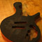 Electronics and pickup cavities on an ebony bass