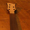 Curly maple neck shim on a black walnut bass guitar neck