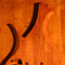Back of a mahogany four string custom bass