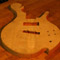 Lower bout on a flamed maple custom bass guitar