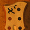 Xylem logo on a curly maple bass headstock