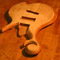 Carved scroll and arm bevel on a custom bass with flamed maple top