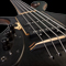 Front of the custom bass from a low side angle showing the ebony top, preamp cover, killswitch, bridge and more