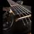 Scroll, neck and body of the left-handed bass from a wide angle at the back