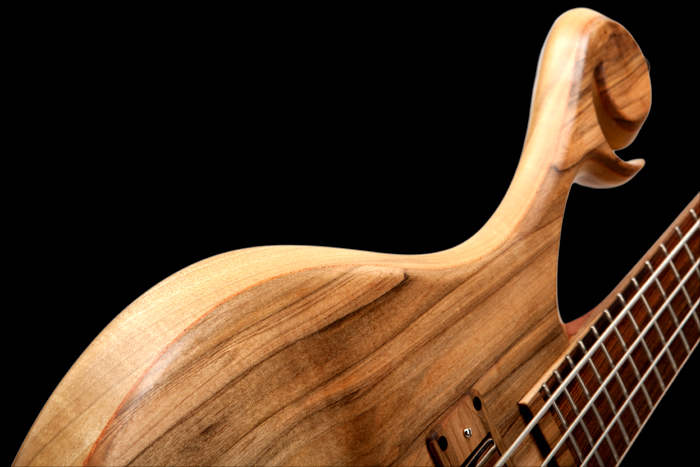 Mahogany veneer accent between top and core woods on a Xylem custom 4 string bass