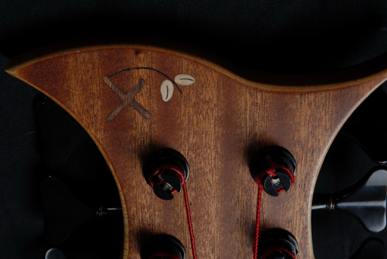 Closeup of logo inlay and headstock