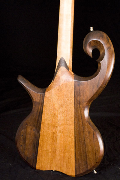 Back of the bass guitar body; scroll, black walnut bookmatch and mahogany bookmatch are shown