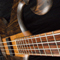 Black walnut scroll and cocobolo fretboard of the bass from a wide angle
