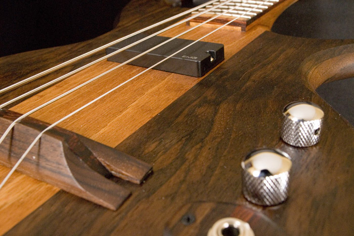 Output jack, volume and tone controls and EMG-DC pickup of the 4 string bass