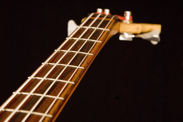 Closeup of the bass'cocobolo fretboard w/ mahogany sstringers and cocobolo binding