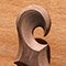 Carved black walnut scroll on a custom guitar