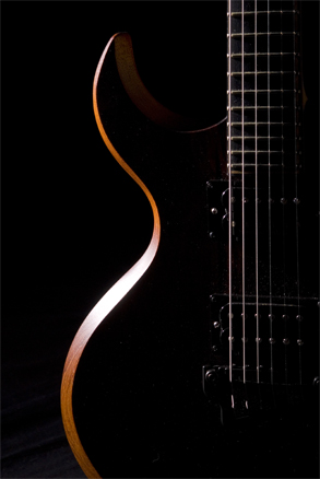 The custom guitar's contour highlighted
