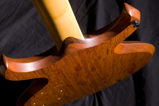 Back of the guitar body showing figured jatoba grain and cocobolo neck shim