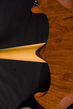Guitar rear showing horns, cocobolo neck shim and rock maple neck