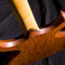 Wide angle of guitar body rear showing figured jatoba grain and cocobolo neck shim