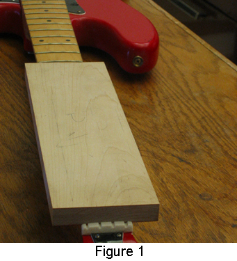 Placing a block of wood against the nut and tapping it with a mallet to remove the nut