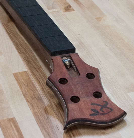 Four-string bass headstock with bloodwood cap