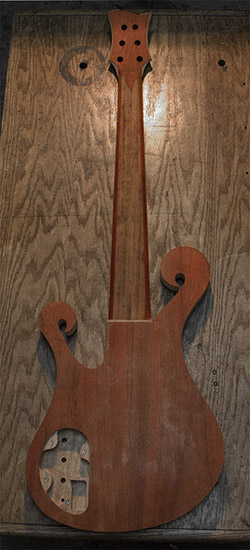 Exotic 6-string bass guitar with two scrolls