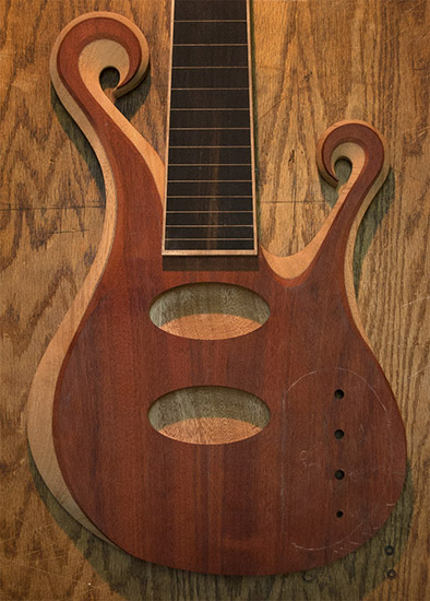 Carved 6-string bass body with bloodwood top