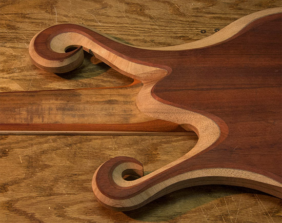 Heel of a neck-thru 6-string fretless bass guitar