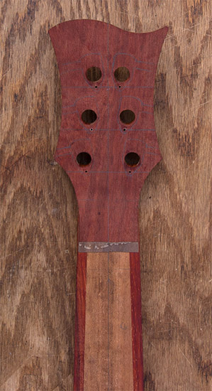 Bloodwood headstock of a 6-string custom bass guitar, back