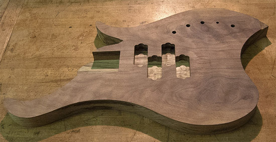Custom bass with dual P-Bass pickup routes, figured walnut top