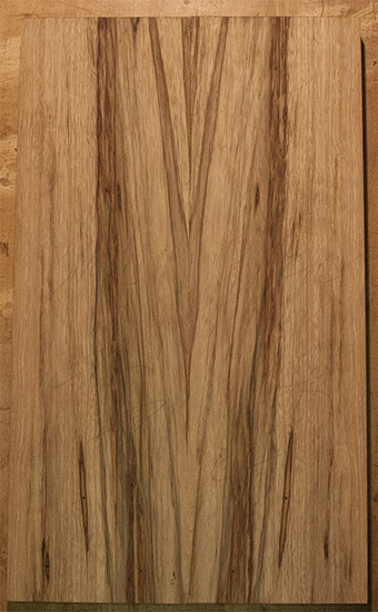 Custom bass body made of book-matched black limba