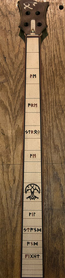 4-string bass neck with maple fretboard, custom inlays that say "we are strong, we will stand and fight"