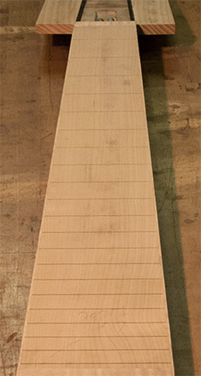 Quartersawn maple fretboard of an 8-string custom bass
