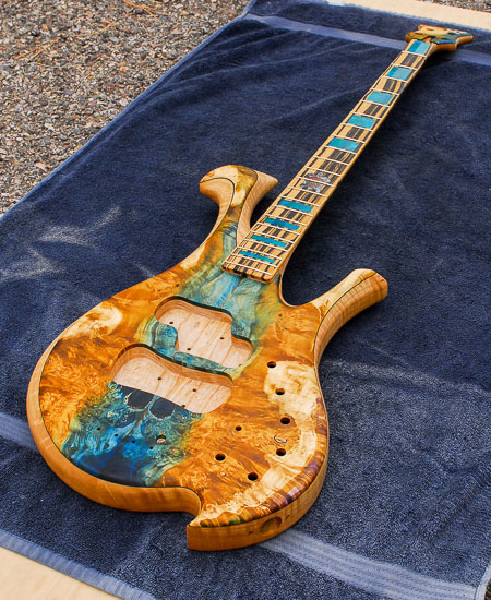 Stabilized colored maple burl top on a Xylem custom bass