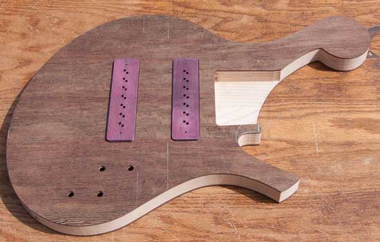 Custom 7-string bass with purpleheart pickup covers