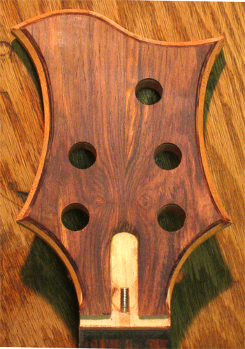 Close up of the bookmatched cocobolo headstock of the custom bass after carving