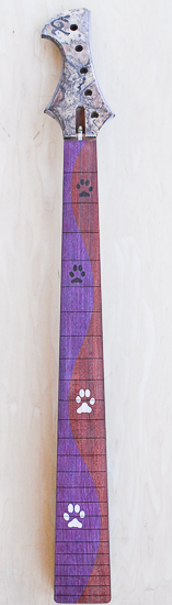 Bass guitar neck with dog paw inlays on a purple and red fretboard