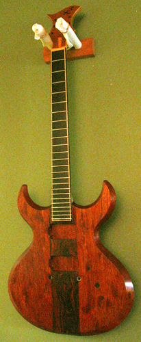 The custom guitar hanging on the wall while the finish dries