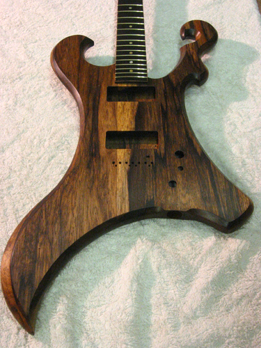 Front of the 7 string guitar after finishing, showing Jescar EVO gold-alloy frets