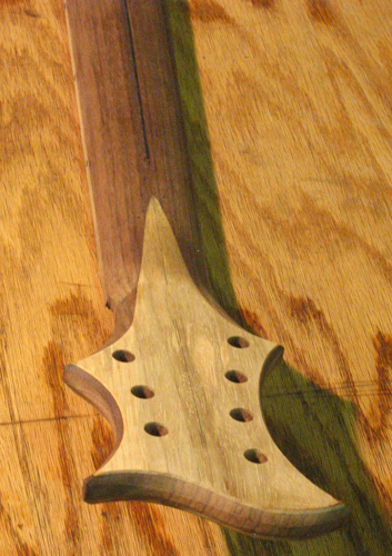 Back of the guitar's black walnut neck with black limba veneered headstock