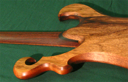 The back of the custom guitar showing the black walnut neck, ebony heel and black limba scroll